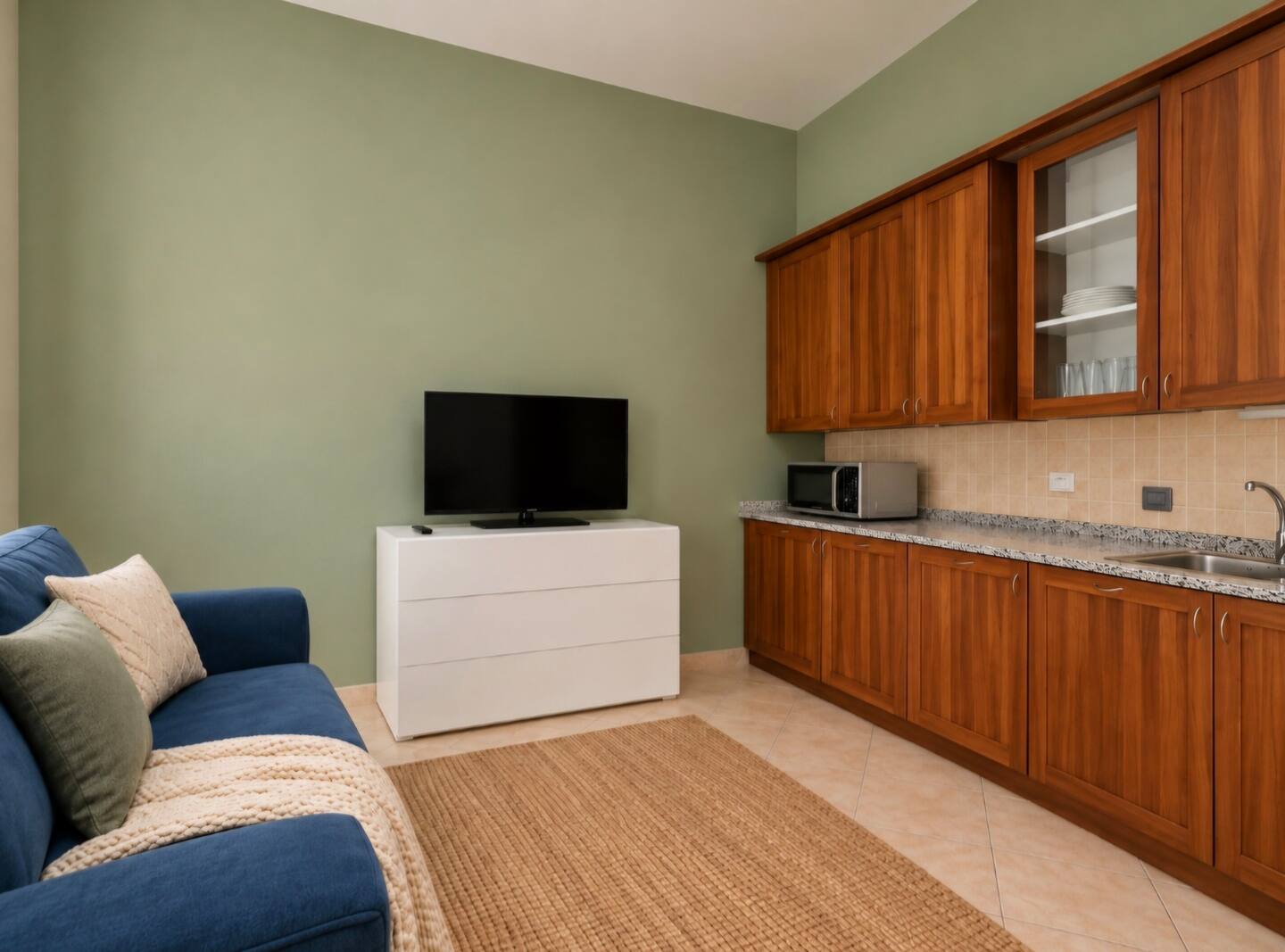 The apartment lounge with TV and wooden kitchen