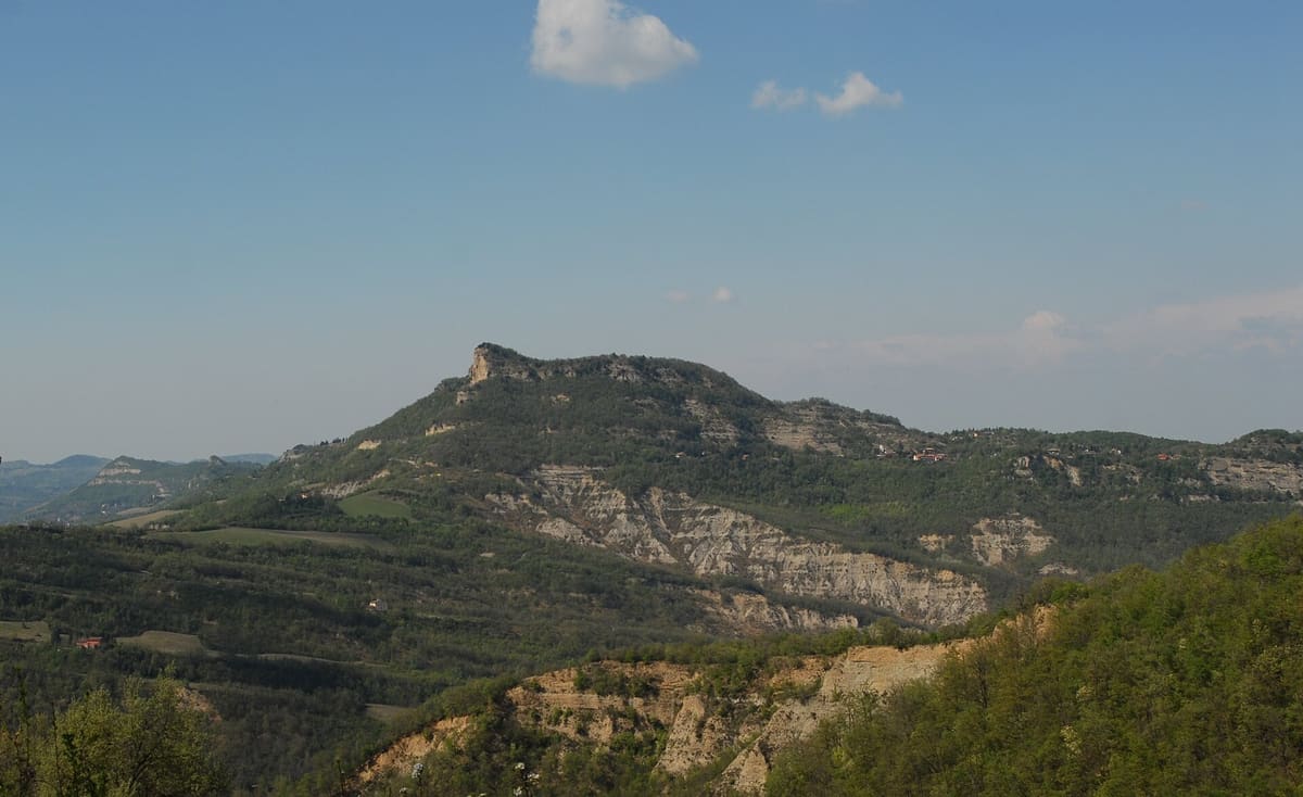 The sandstone cliffs of Monte Adone above the woods of the Bolognese Apennines