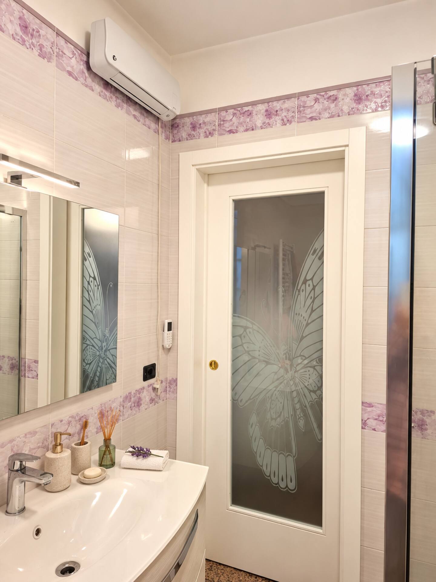 The upper-floor bathroom with the butterfly-decorated door