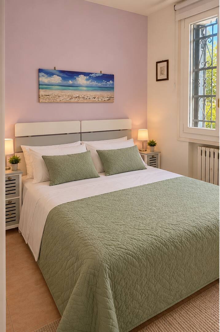 The private room on the upper floor, with double bed and sage-green bedspread
