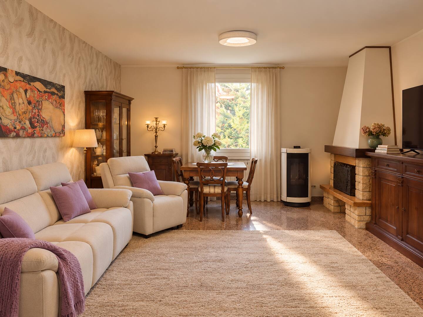 The upper-floor lounge with light sofas, dining table and fireplace