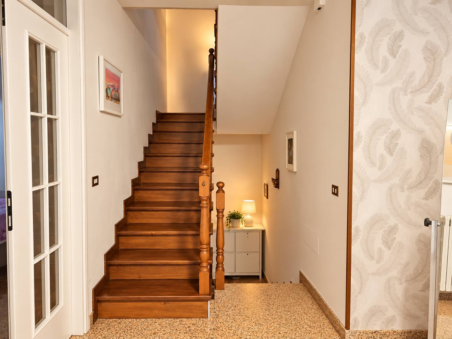 The wooden staircase leading to the upper floor
